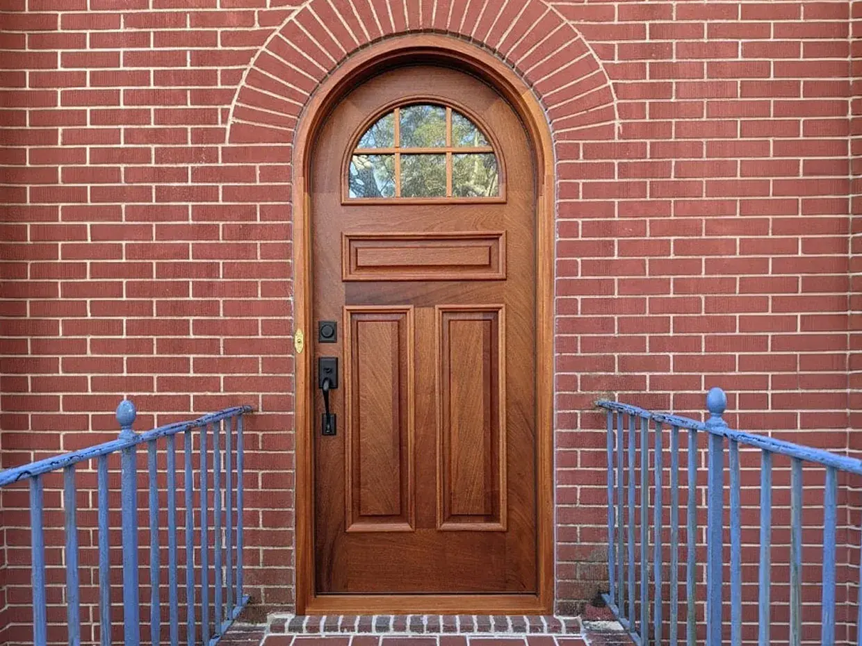 arched-mahogany-door-on-brick-wall